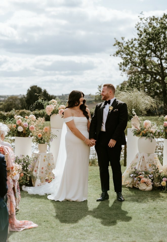 Bride and groom holding hands at their wedding ceremony