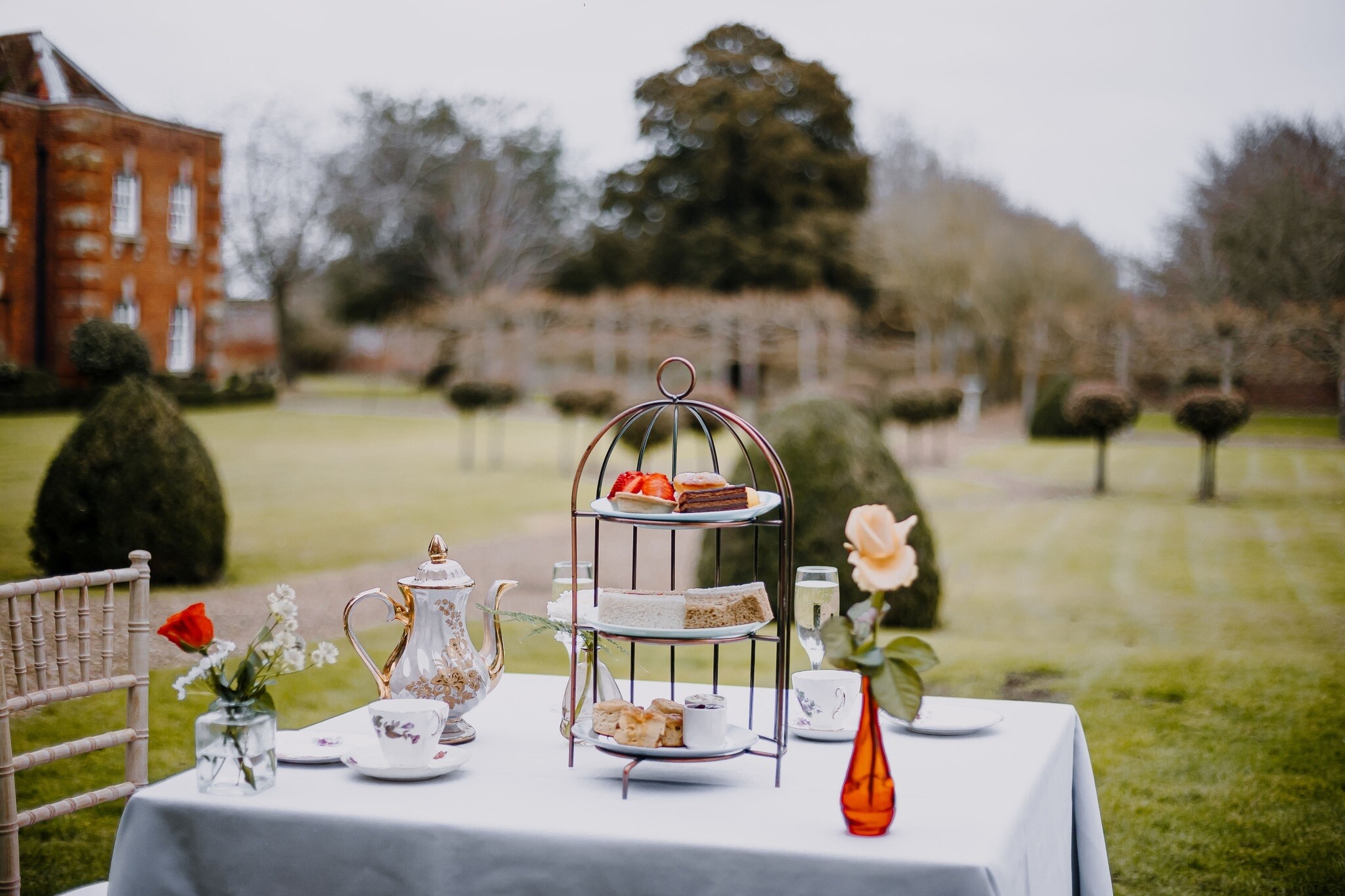 Afternoon tea set up outside in the grounds of Chicheley Hall wedding venue