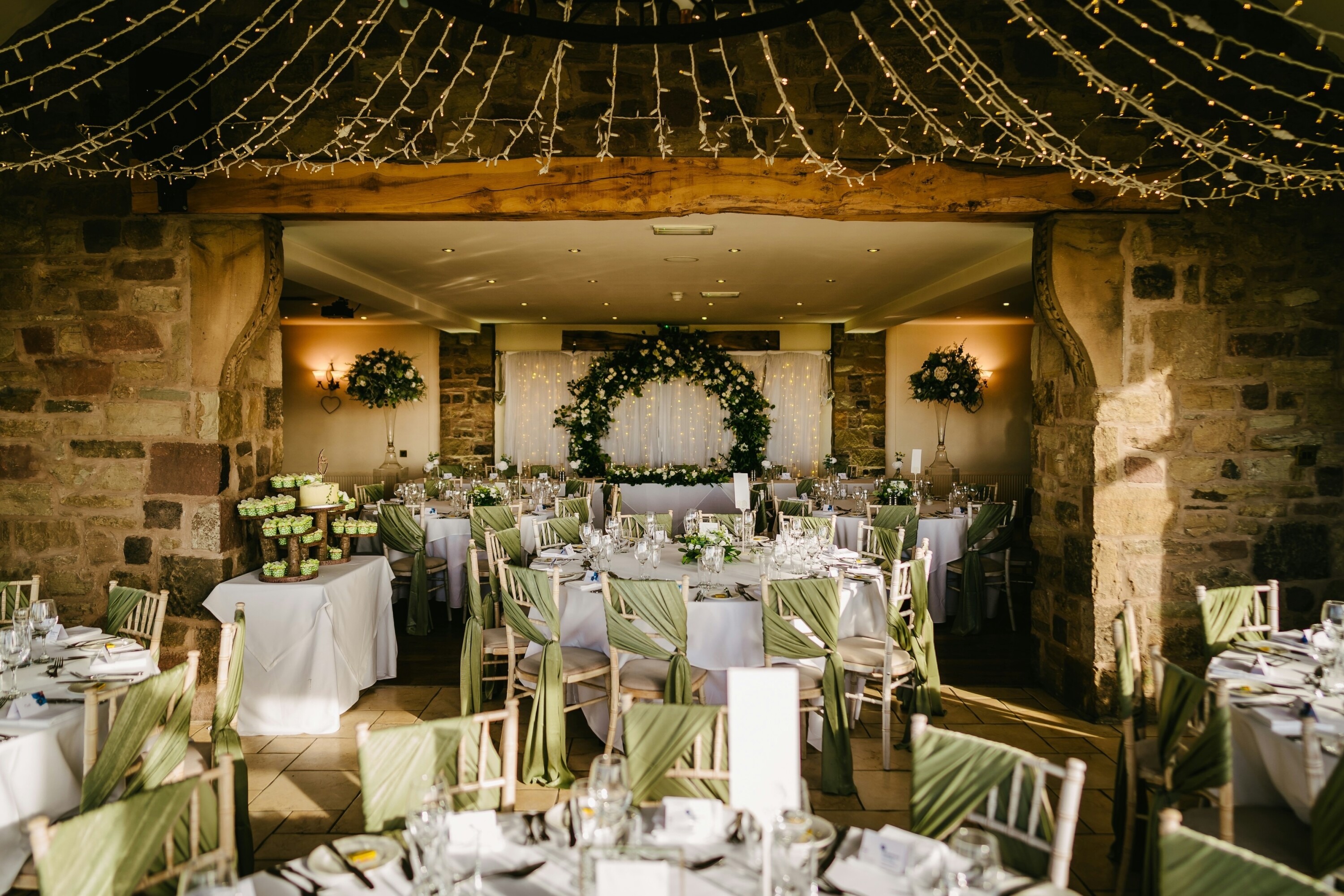 Interior of a barn wedding venue decorated for a wedding breakfast
