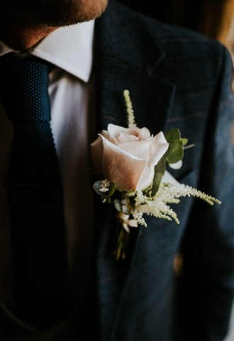 Pink rose button hole on grooms jacket at Hedsor House wedding venue Buckinghamshire