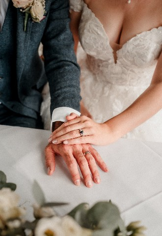 Wedding couple rings at ceremony Southdowns Manor West Sussex