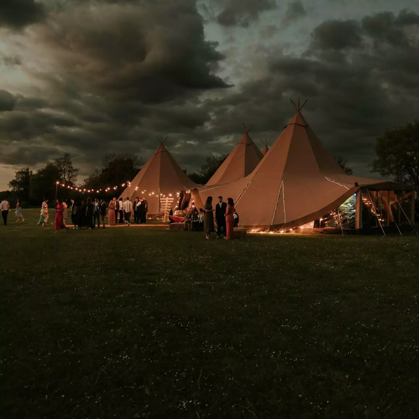 Sywell Grange tipi wedding at dusk with wedding guests
