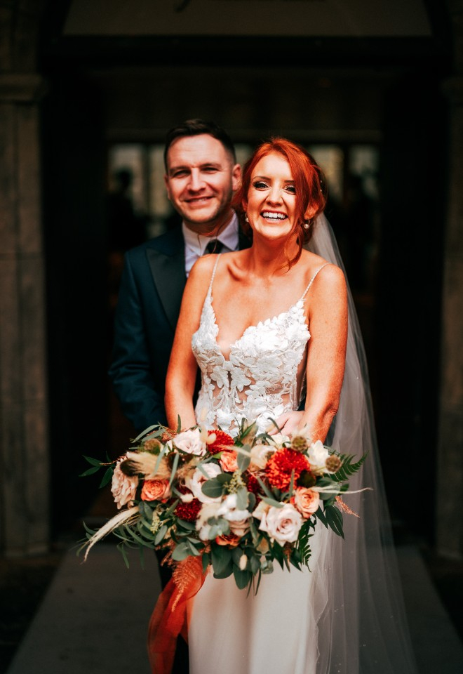 Bride and Groom smiling at the camera