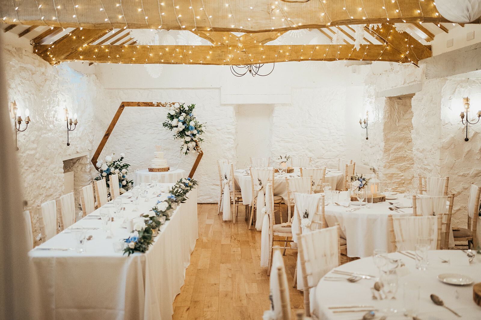 Interior of wedding barn at Bickley Mill Inn set for wedding breakfast