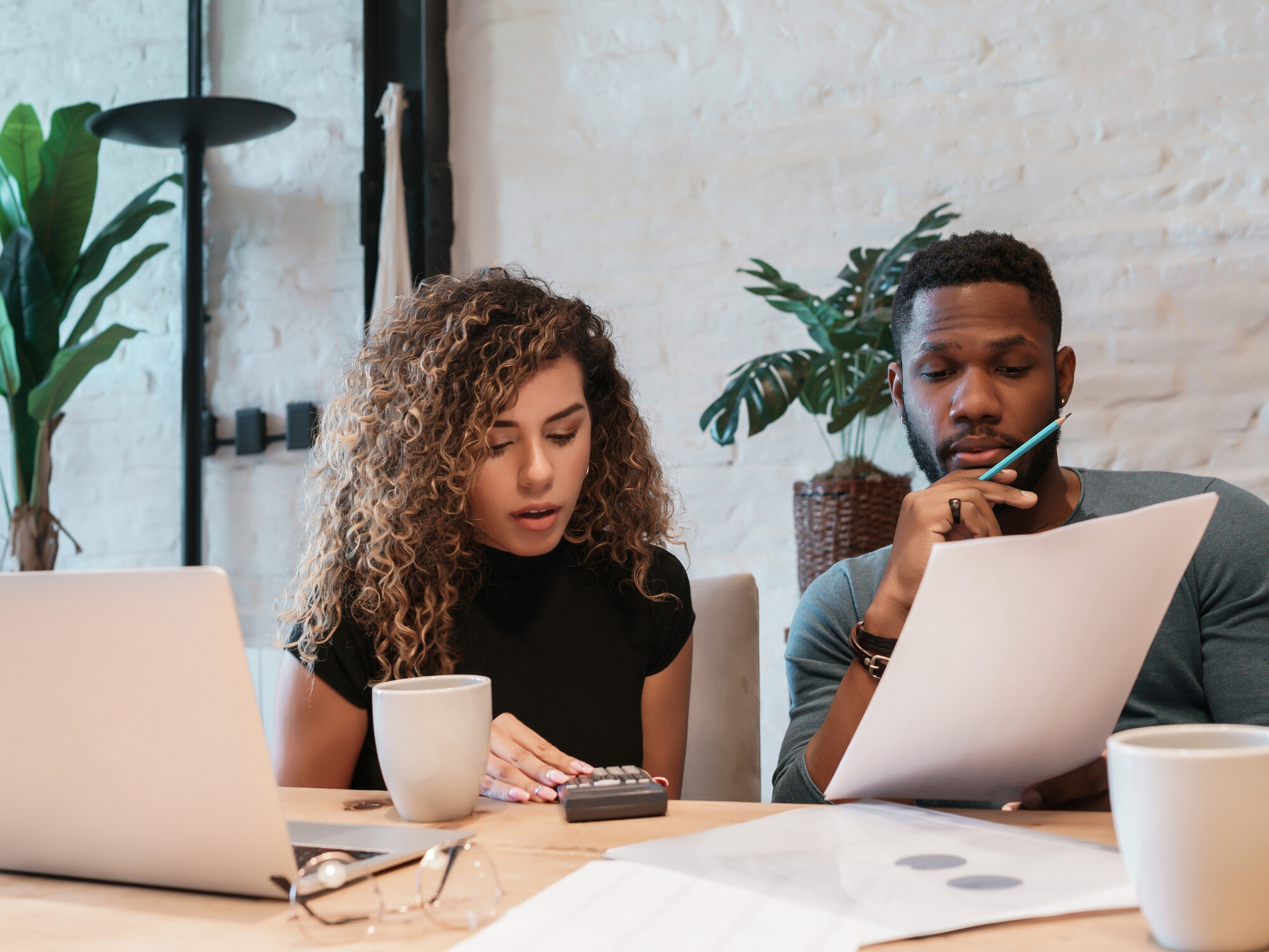 Engaged couple reviewing finances while planning their wedding