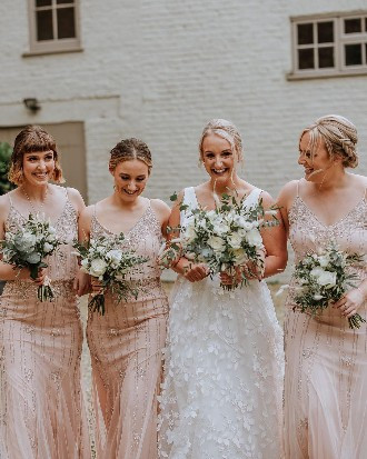 Bridesmaids in Pale Pink Sparkly dresses with a bride in a white gown
