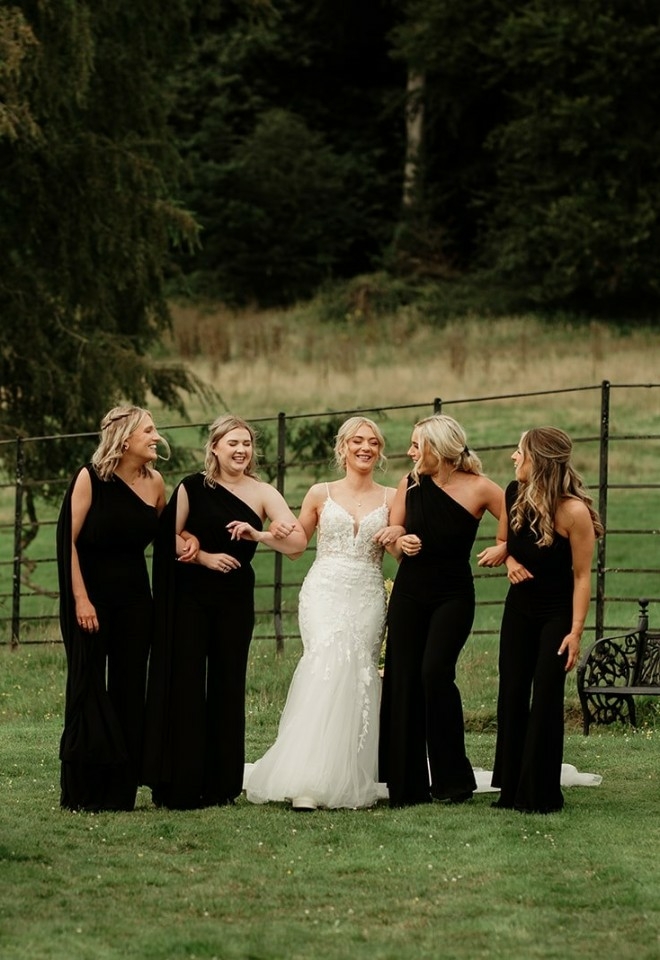 Chloe standing with her bridesmaids in the garden