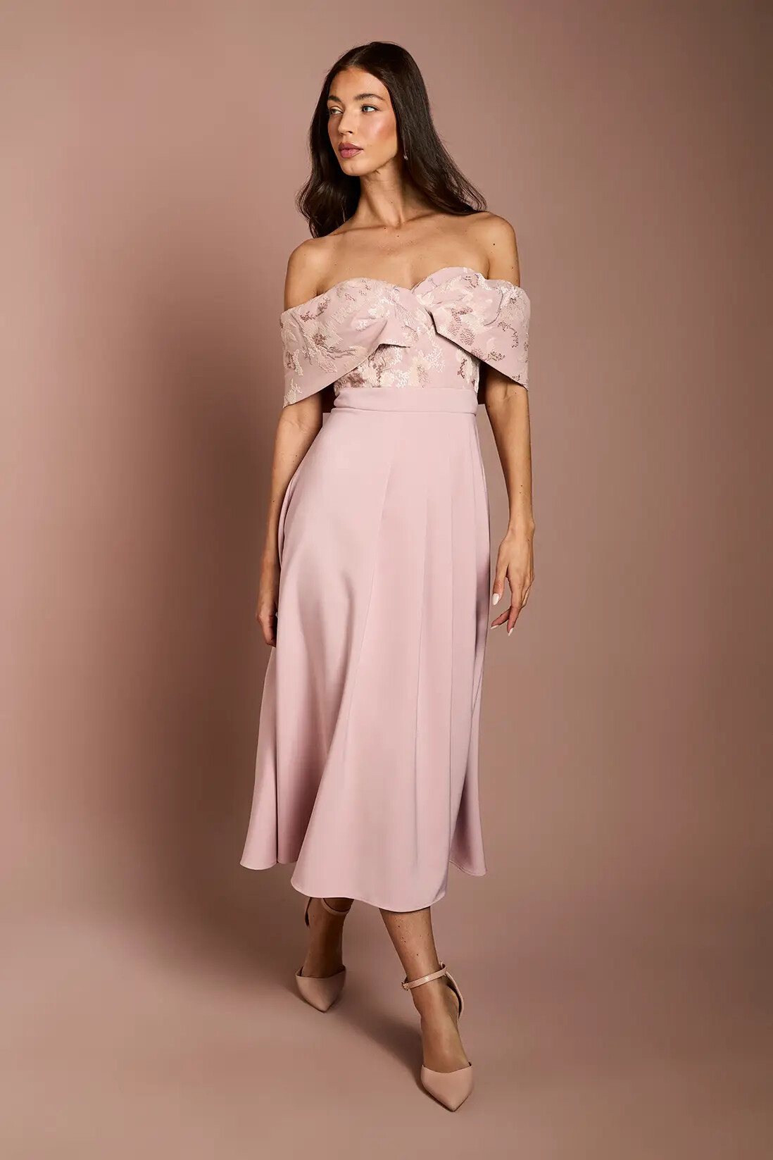 Model wearing pink detailed mid length dress