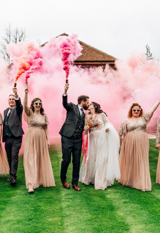 Wedding party with smoke bombs outside The Post Barn