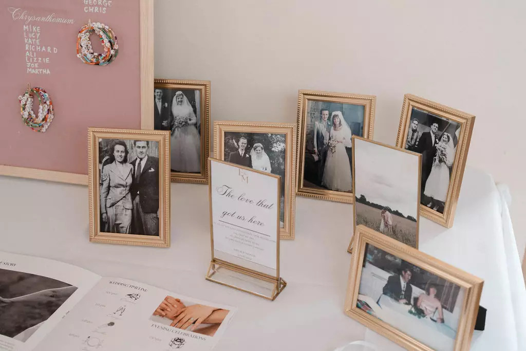 Wedding memory table displaying framed photographs of loved ones who have passed away.