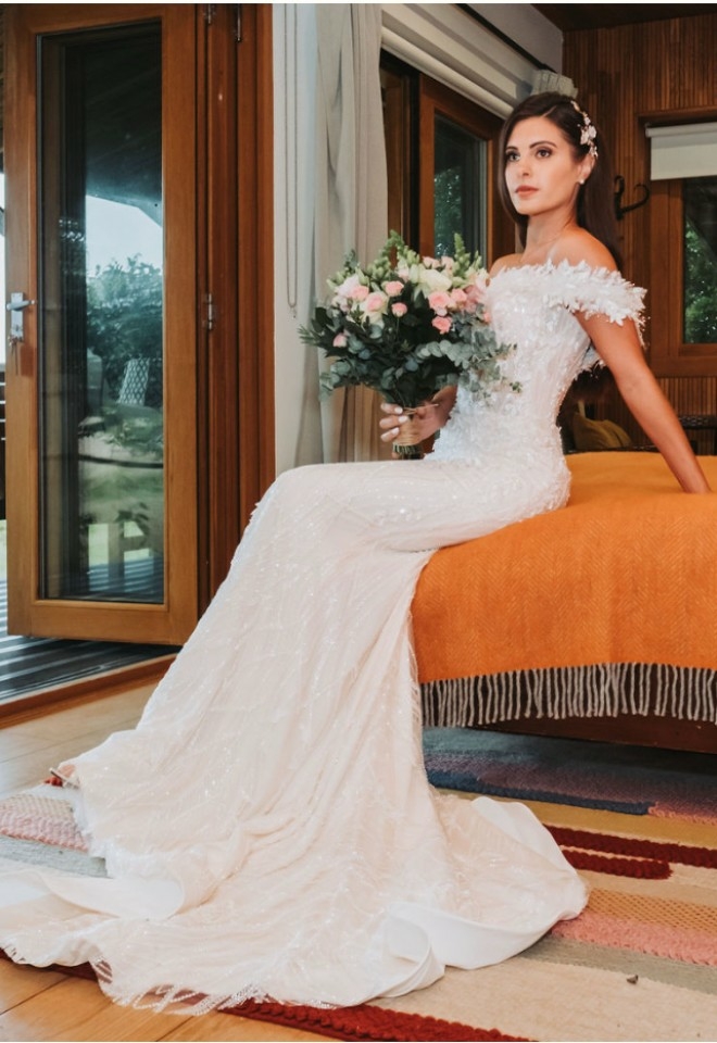 Bride sitting on the bed in the lodge