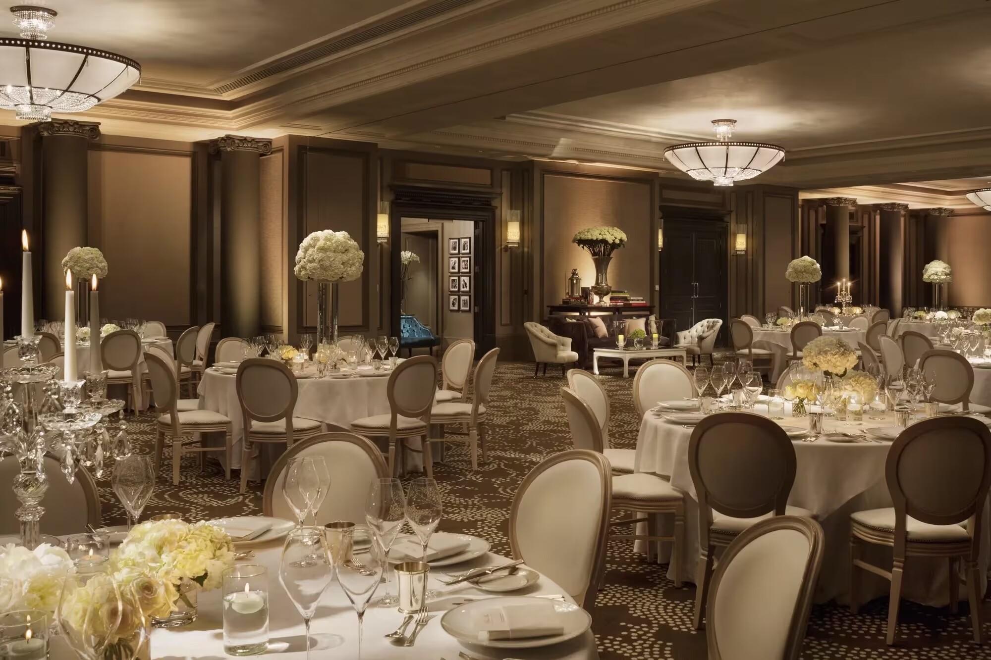 Wedding breakfast set up with round tables and floral centrepieces at the Rosewood London.