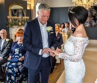 bride and groom exchanging rings