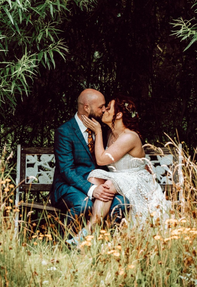 Bride and Groom kissing in the gardens at Breckenhill
