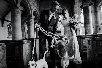 Lucy and Paul in the church with their dogs and child after ceremony