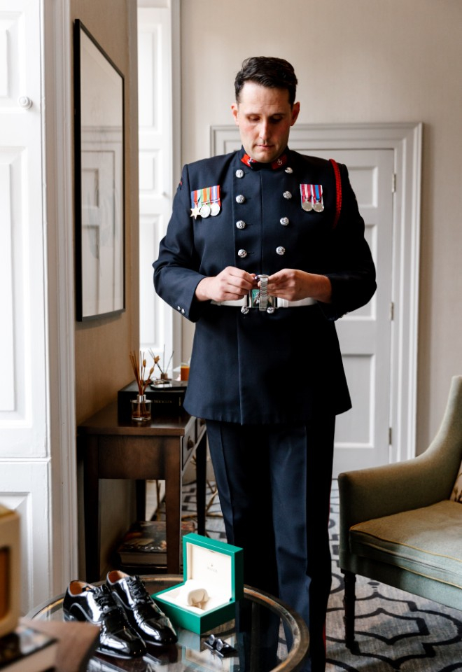 Groom gets dressed in his wedding ceremony attire