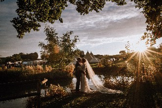 Bride and Groom by the lake at Alcott Weddings