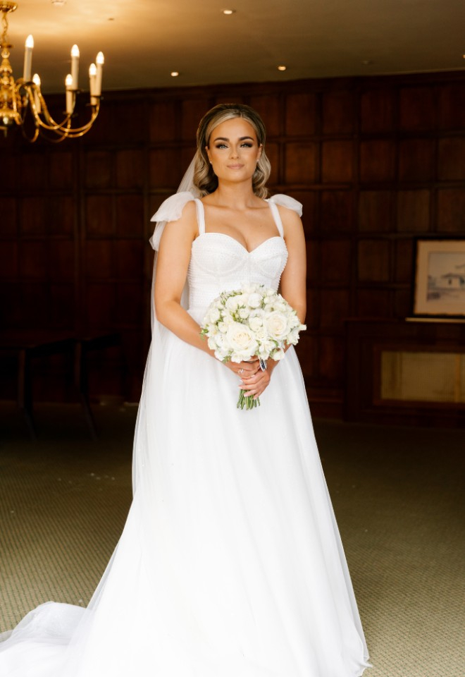 Bride ready for wedding ceremony with bouquet in hand