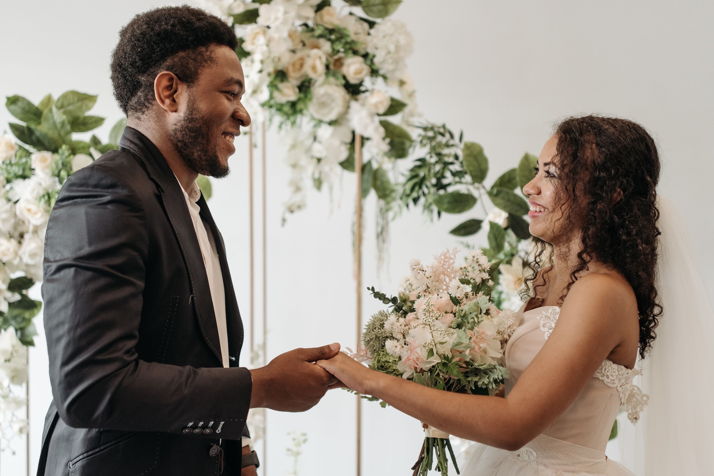 Bride and groom hold hands during ceremony
