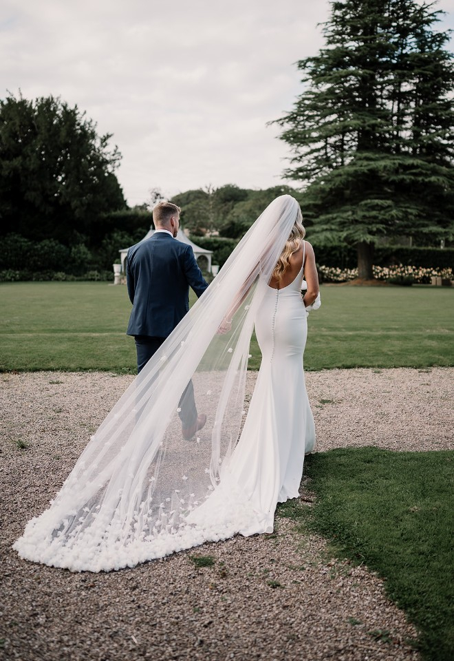 Bride and groom walk through the venue grounds