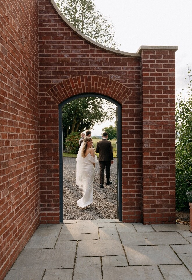 Bride smiles as she takes a private moment with her new husband