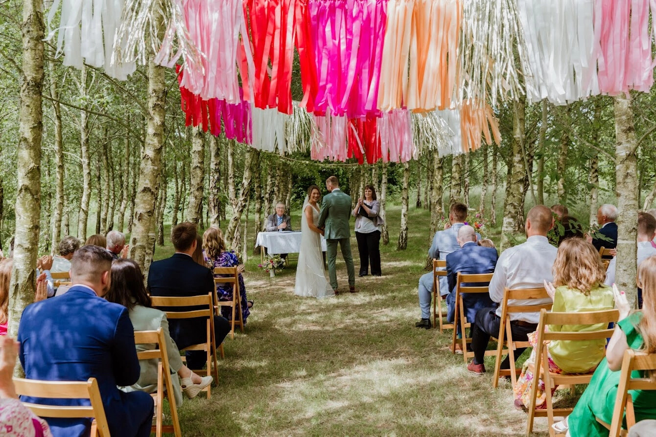 Woodland wedding ceremony taking place at Higher Holcombe