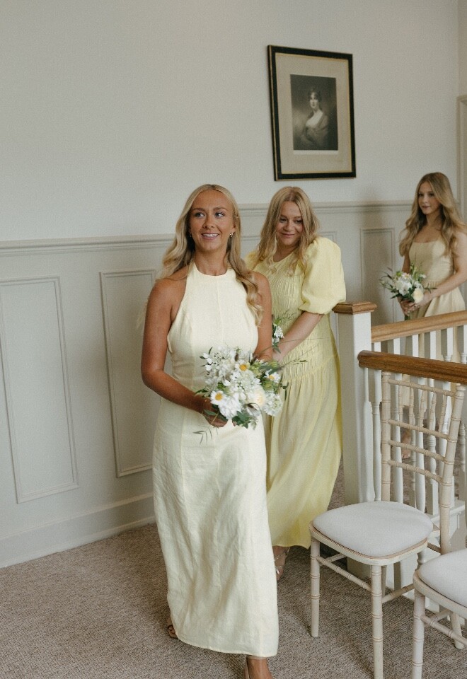 Bridesmaids in mismatching yellow dresses