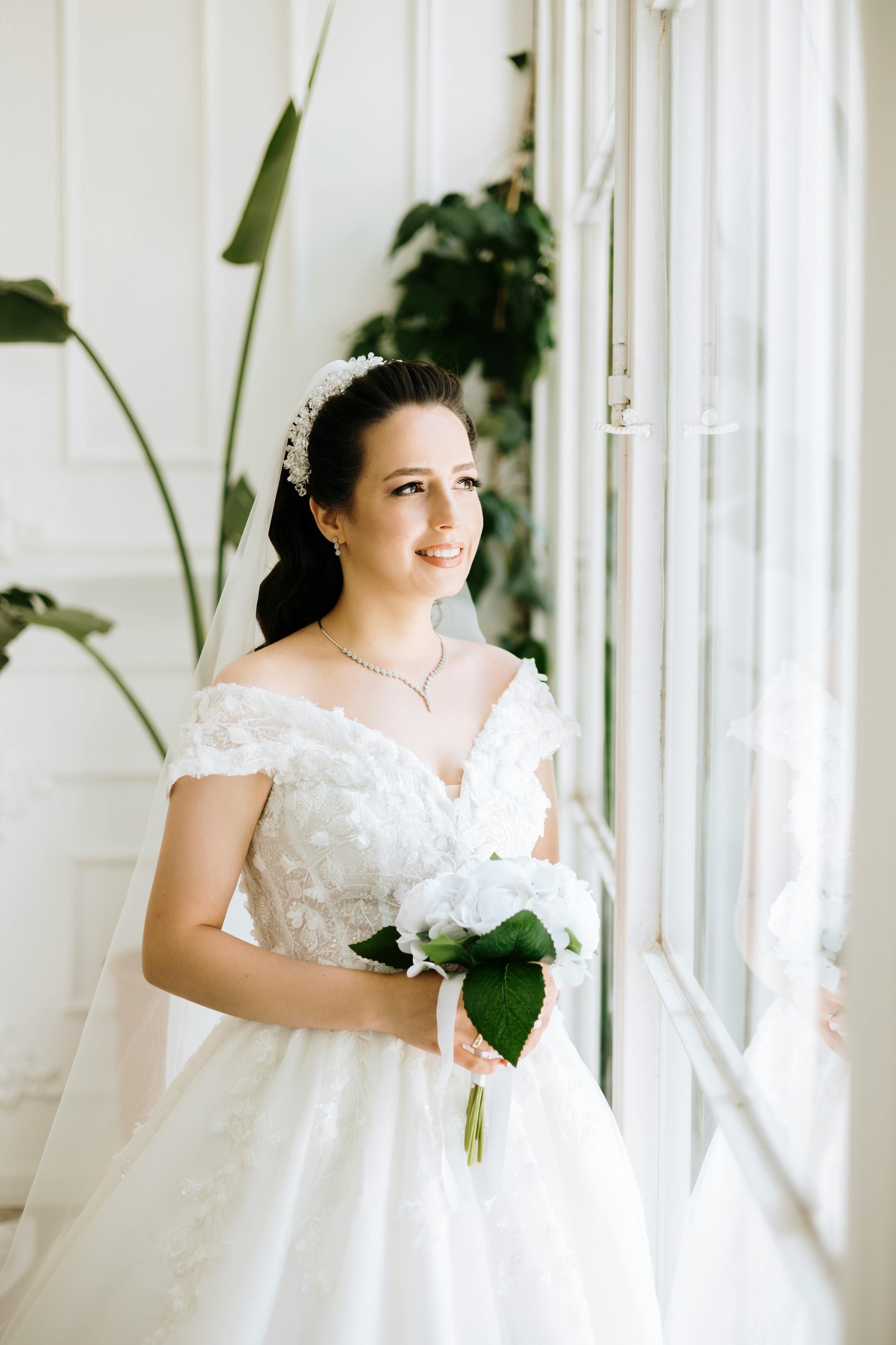 Bride holding a small posy bouquet with white flowers