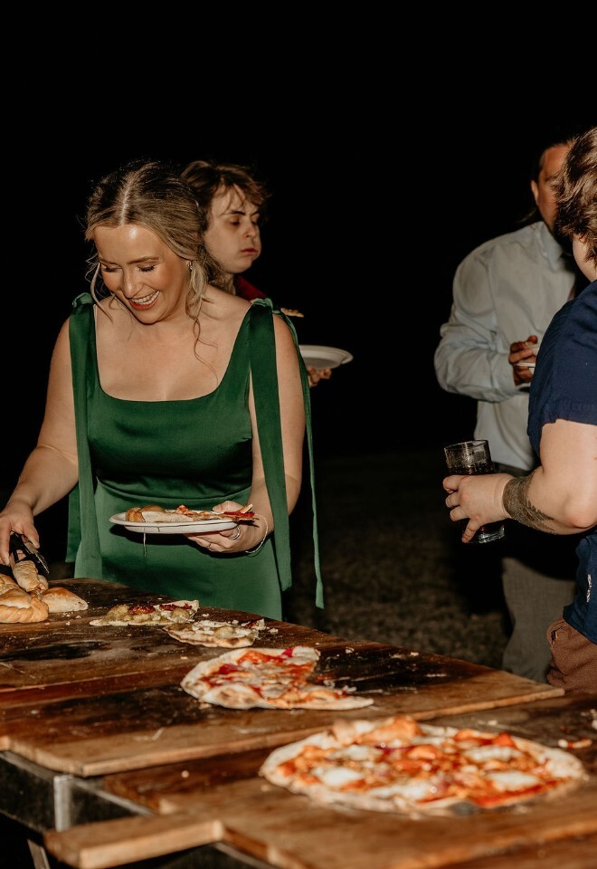 wedding guests having pizza and sandwiches for wedding evening reception 