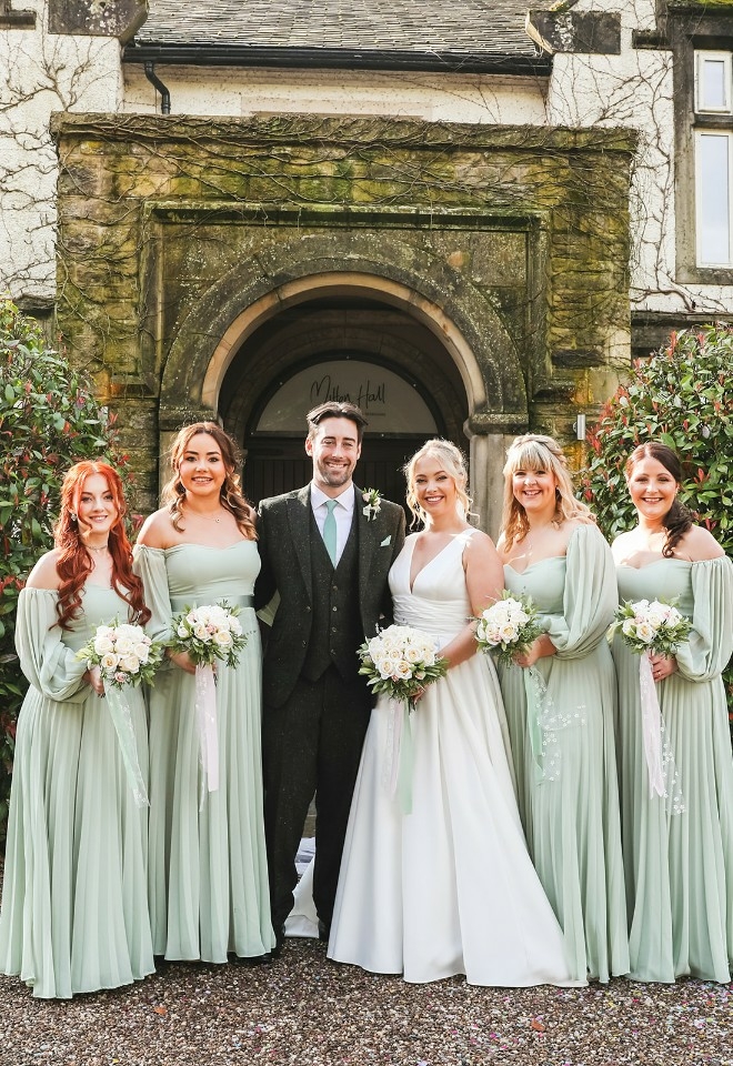 Bride, groom and bridesmaids outside of Mitton Hall