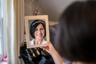 bride looking in the mirror at finished look