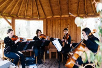 Live music under outdoor shelter at The Oak Tree of Peover