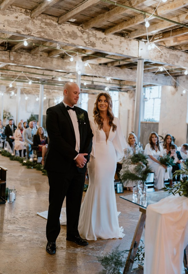 Bride and groom stood at the top of the aisle 