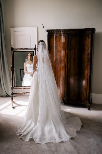 Bride looking in mirror at Ardington House