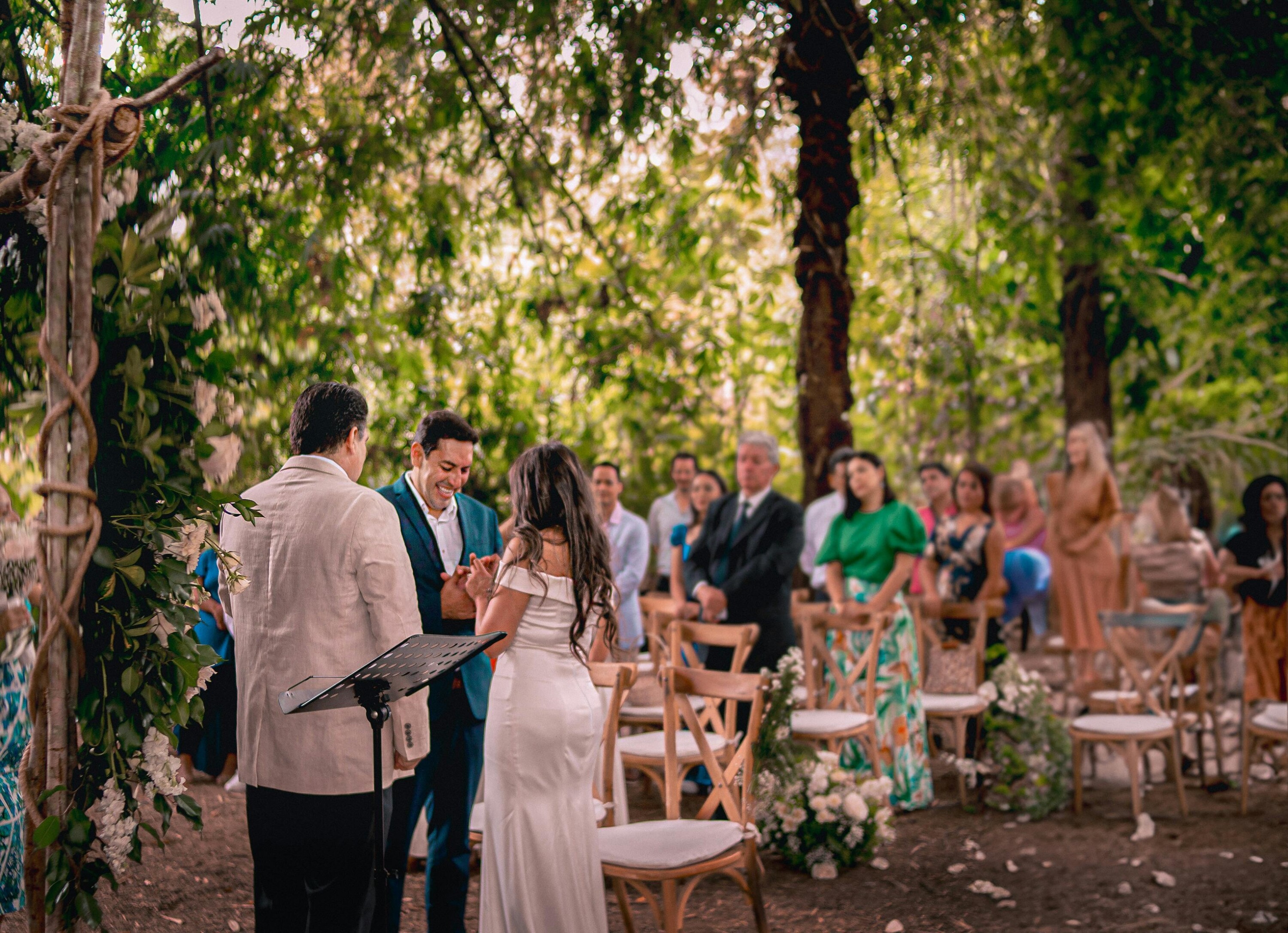 guests watch bride and grooms woodland wedding ceremony 