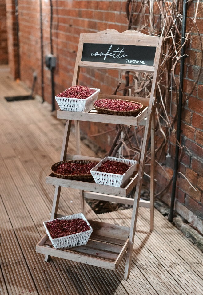 Confetti stand with pink rose petal confetti