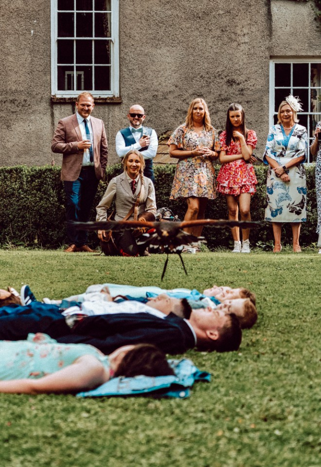 Hawk flying over wedding guests