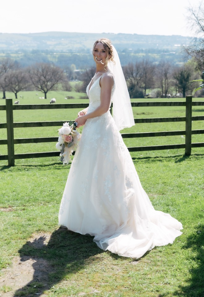 bridal portrait, holding her bouquet