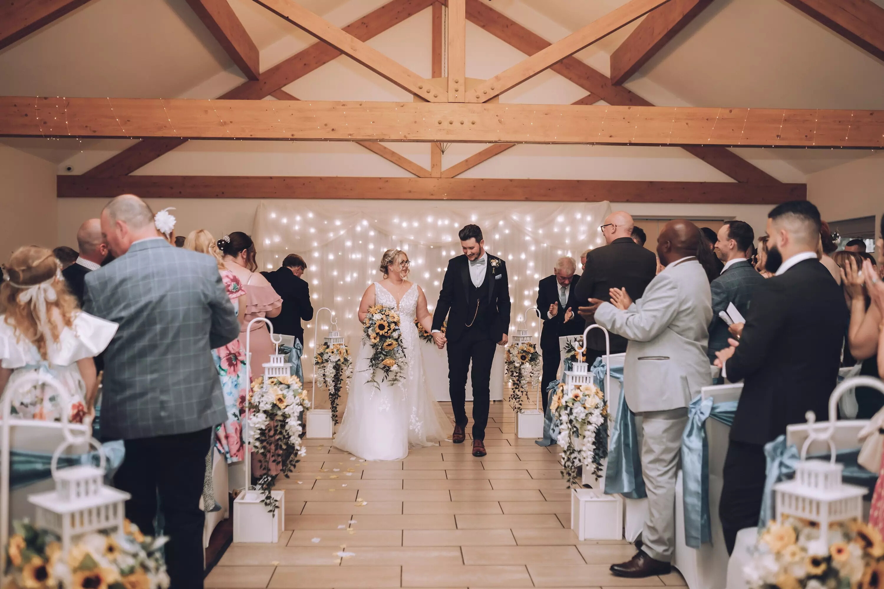 Wedding ceremony with bride and groom walking down the aisle at Draycote Hotel, warwickshire.