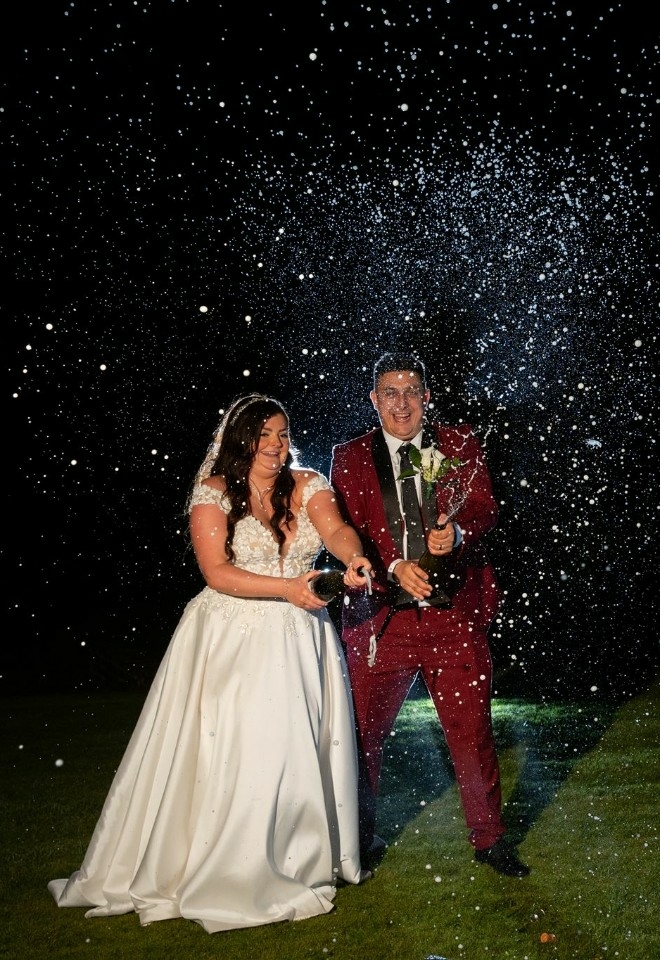 champagne spray bride and groom