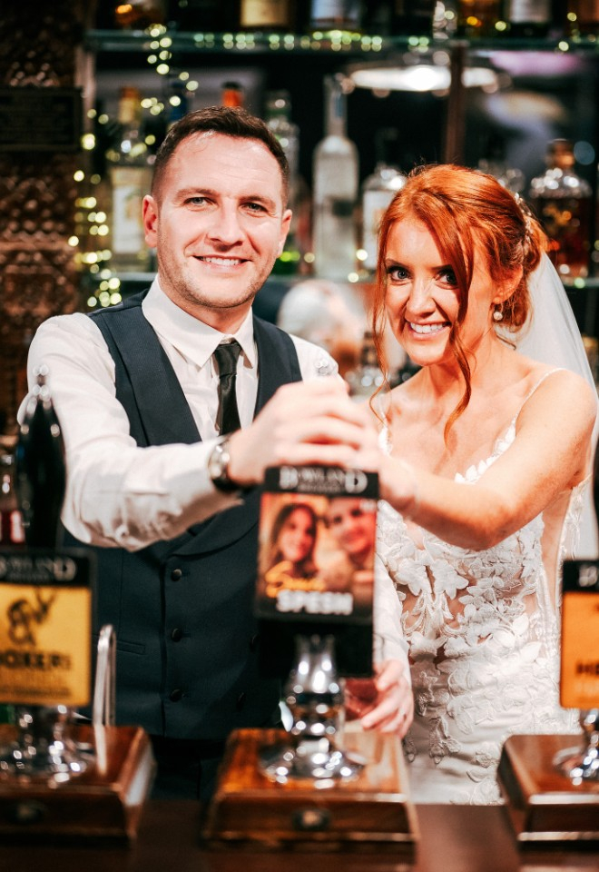 Bride and groom pulling a pint from their personalised beer tap