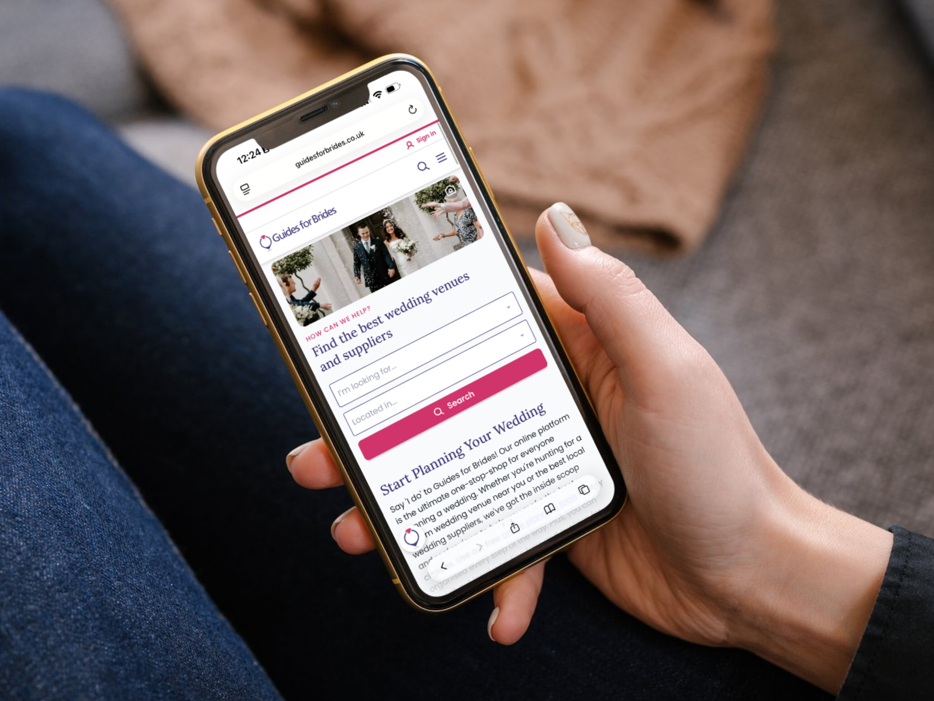 A phone in the hand of a user - the screen shows the Guides for Brides homepage.