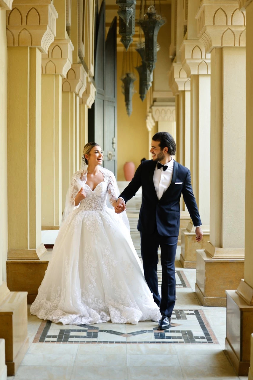 Bide and groom walking through the palace downtown Dubai