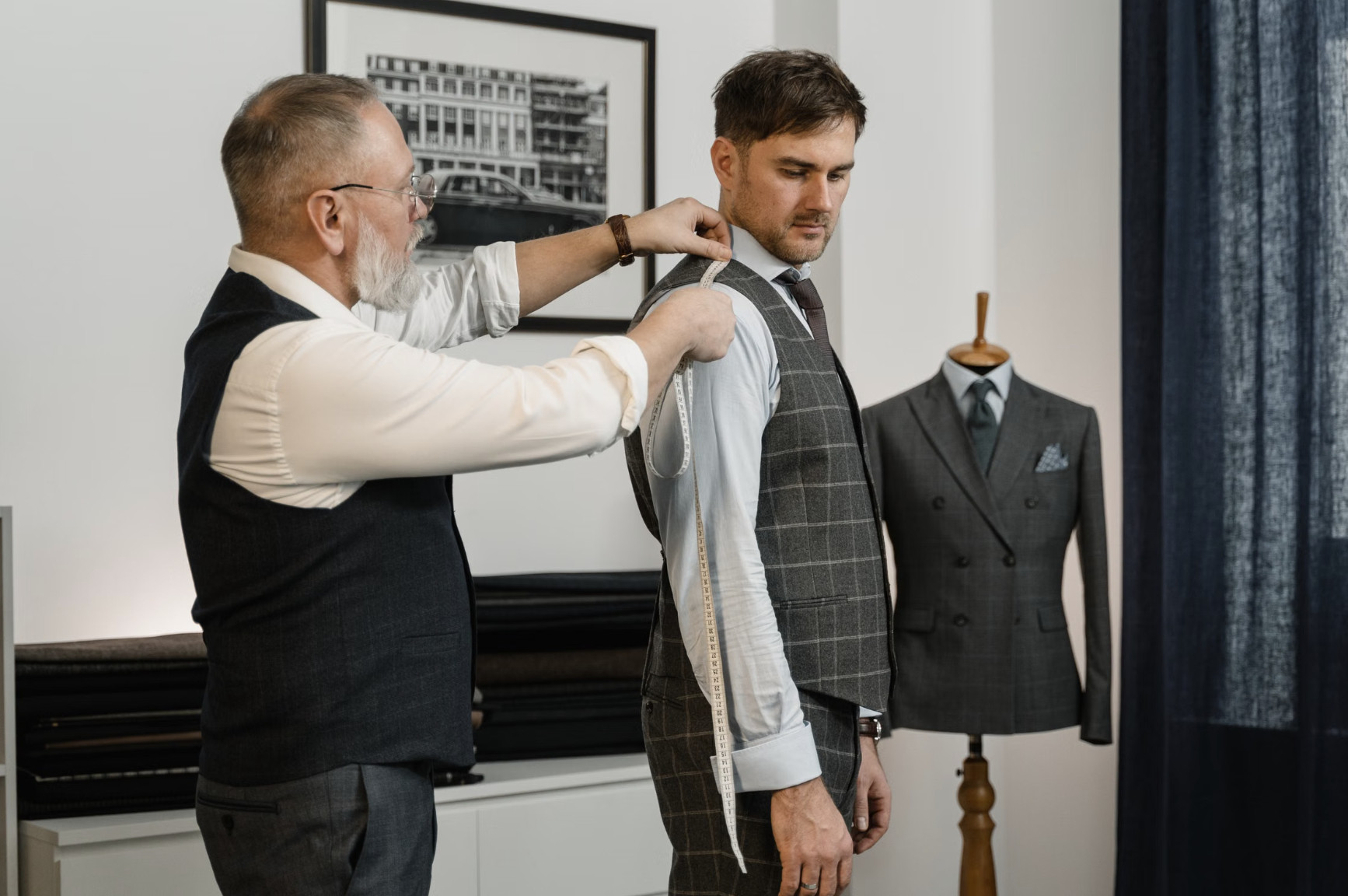 groom wedding suit fitting with tailor