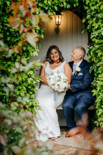 Bride and groom in secret garden at High House
