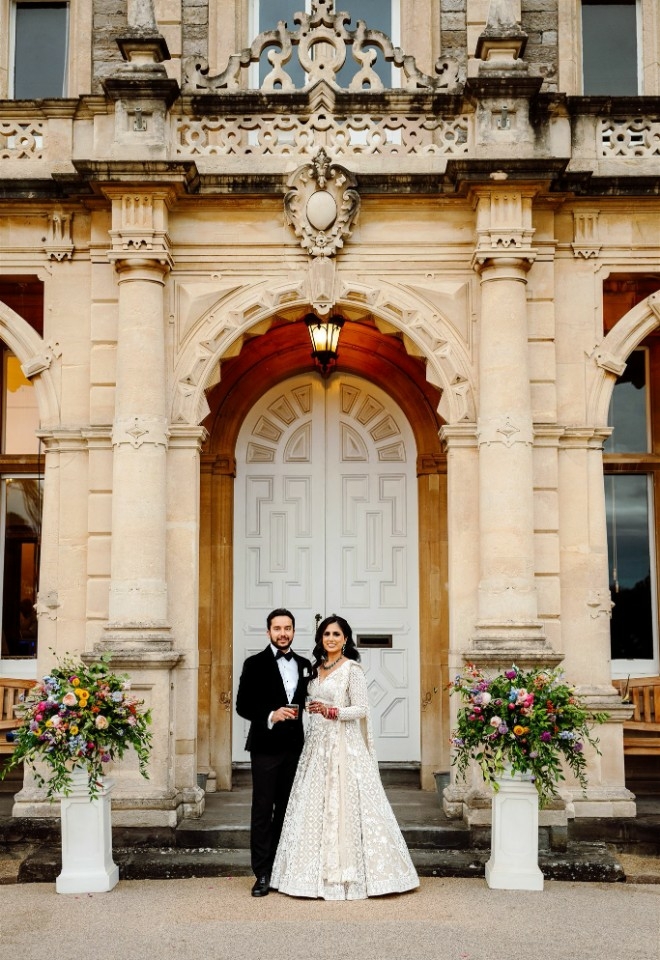 Couple posing in front of the venue