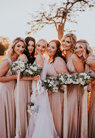 Bride an bridesmaid photo in grounds of Hedsor House wedding venue