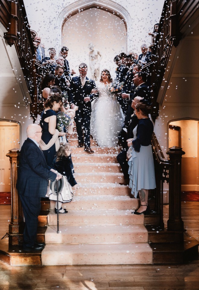 confetti being thrown on wedding couple 