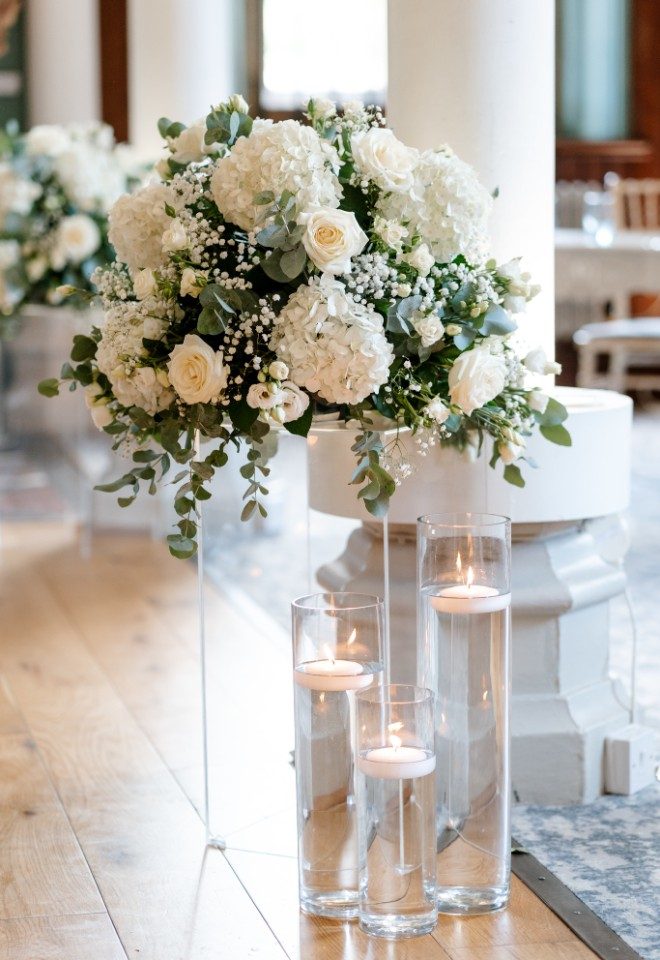 Candles and pedestal flowers down the aisle