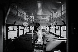 Bride and groom on vintage bus